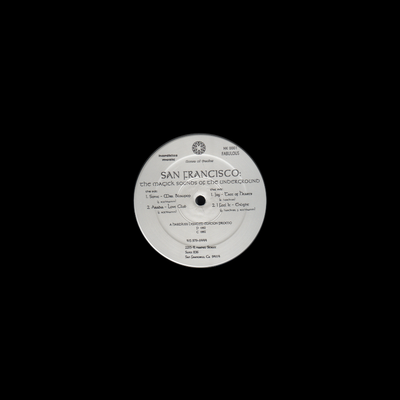 Front cover showing a plain black sleeve with a die cut hole to show the center label